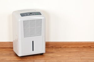 Portable dehumidifier in the edge of a room.