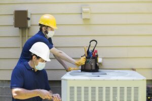 technicians-working-on-air-conditioner-cabinet